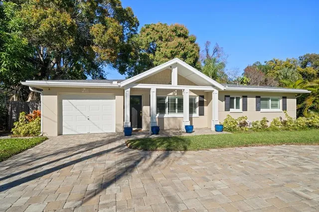 a front view of a house with a yard and porch