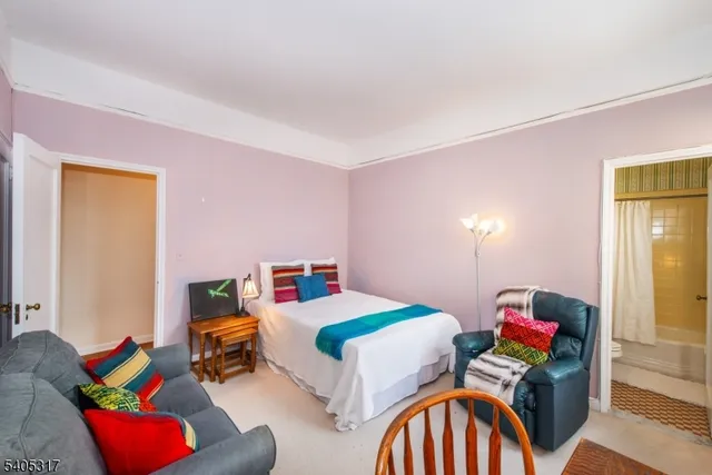 a bedroom with a bed and a couch