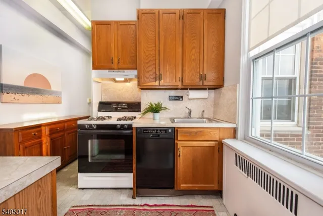 a kitchen with a refrigerator and a stove