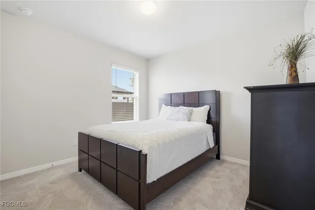 a large white bed in a white room