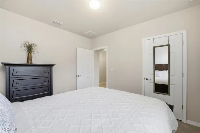 a bedroom with a bed and a dresser