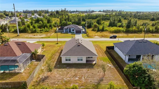 an aerial view of residential houses with outdoor space and seating