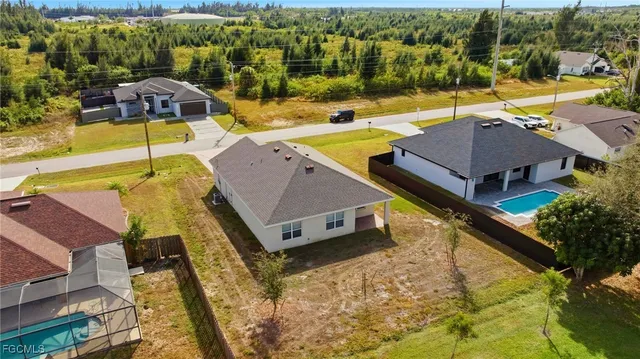 an aerial view of a house with a swimming pool