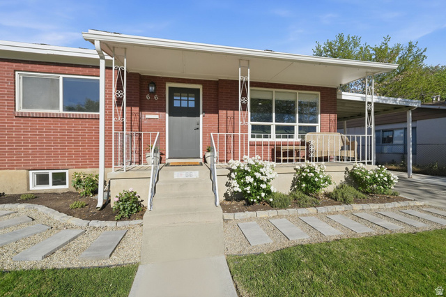 66 South 425 West Bountiful, UT 84010 - Photo 2 of 25 Brick exterior featuring a covered front porch with decorative metal railing