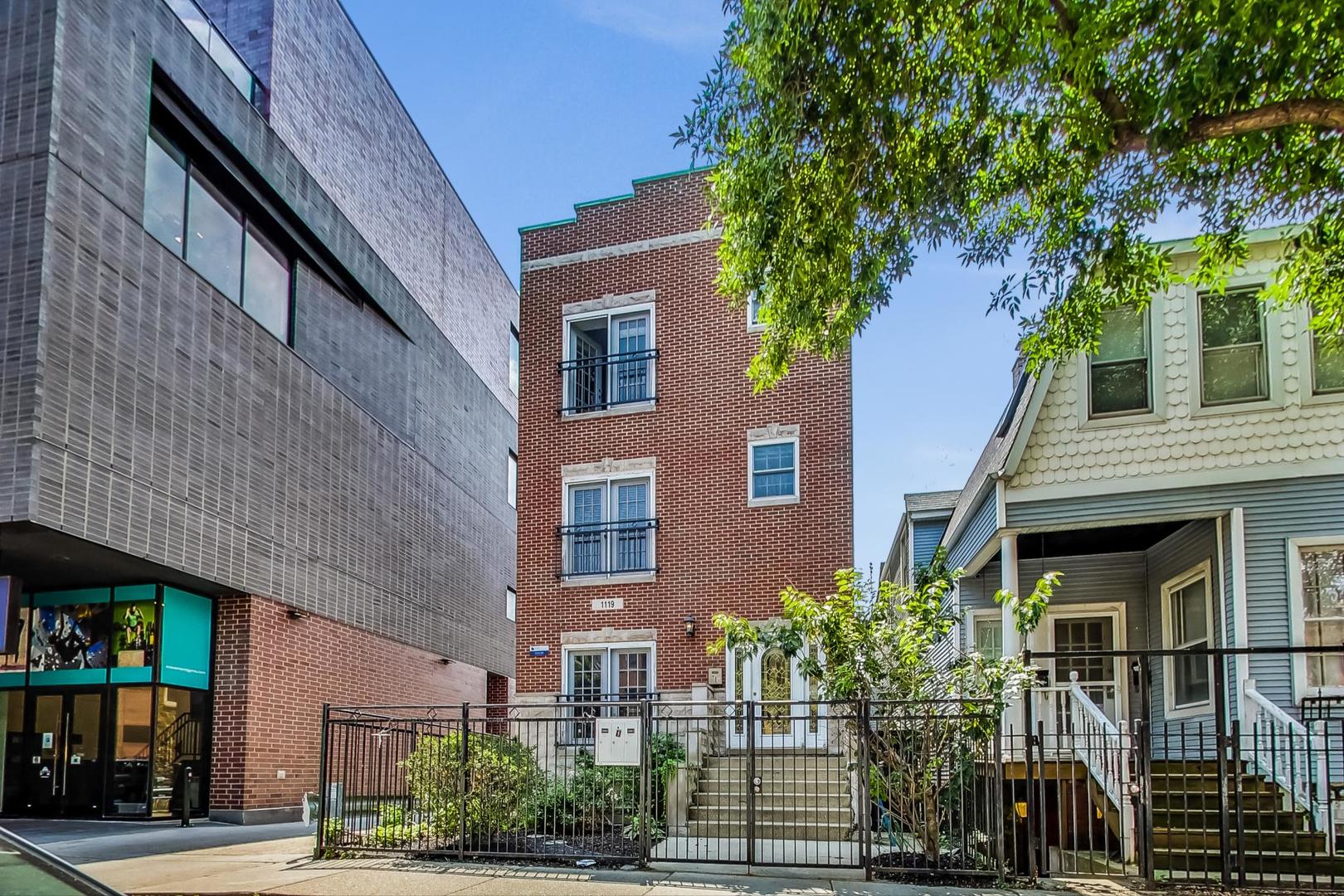 1119 West Addison Street Chicago, IL 60613 - Photo 1 of 36 a front view of a building with garden