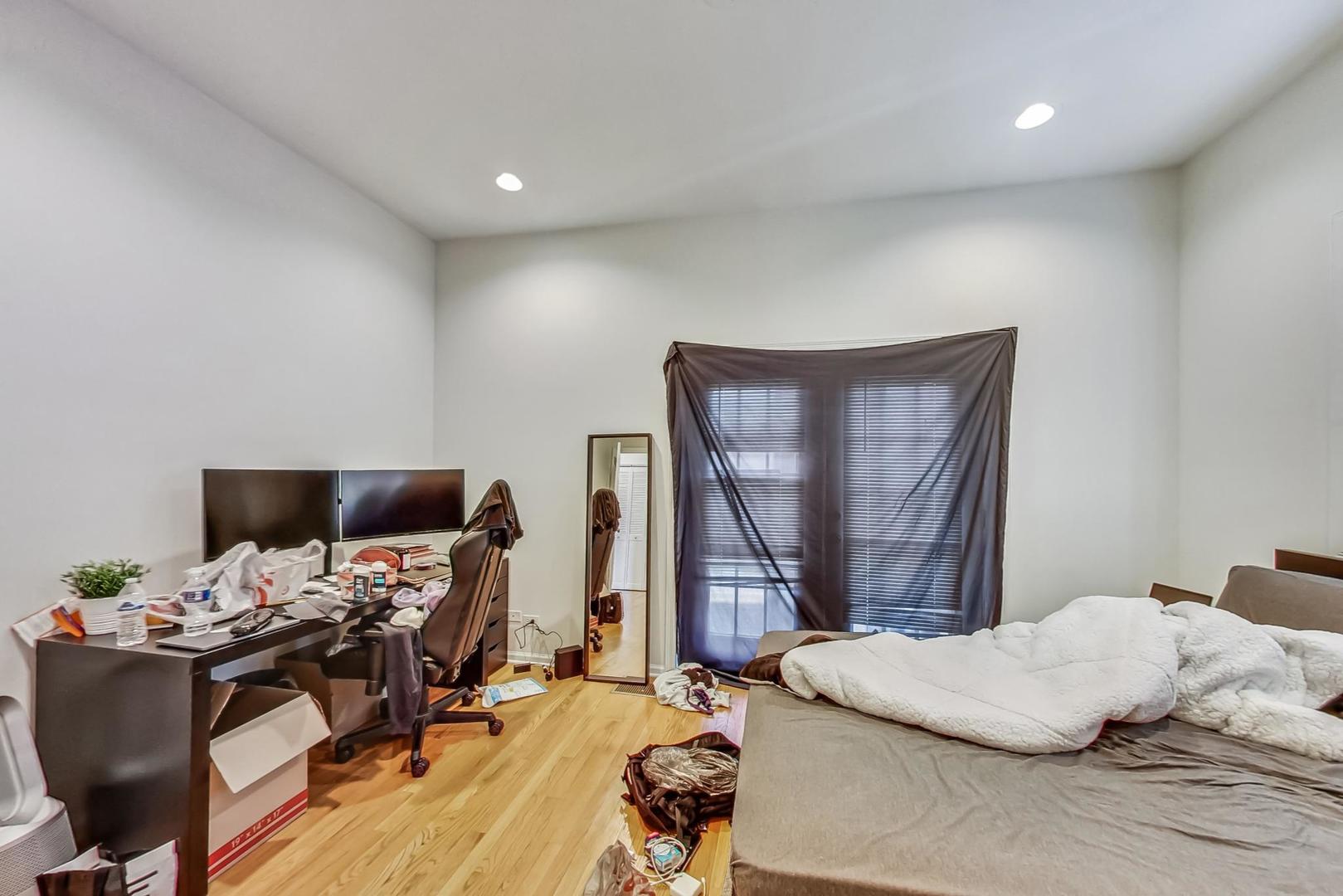 1119 West Addison Street Chicago, IL 60613 - Photo 11 of 36 a bedroom with a bed and a desk