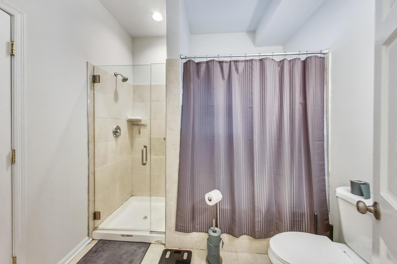 1119 West Addison Street Chicago, IL 60613 - Photo 12 of 36 a bathroom with a toilet a sink and shower