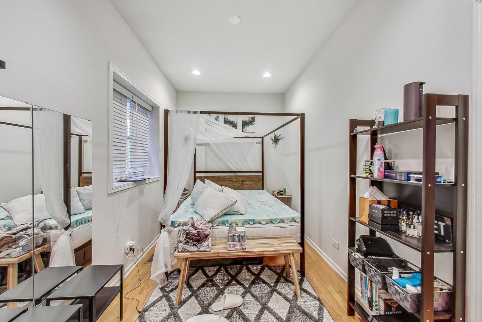 1119 West Addison Street Chicago, IL 60613 - Photo 13 of 36 a bedroom with furniture and a window