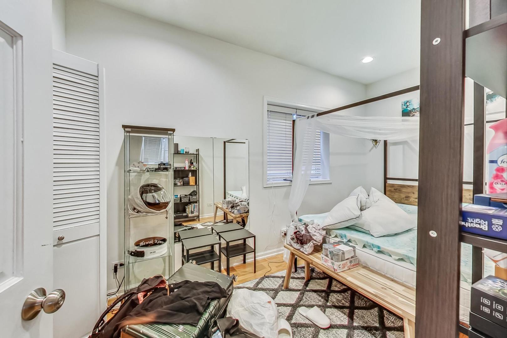 1119 West Addison Street Chicago, IL 60613 - Photo 14 of 36 a bedroom with furniture and a closet