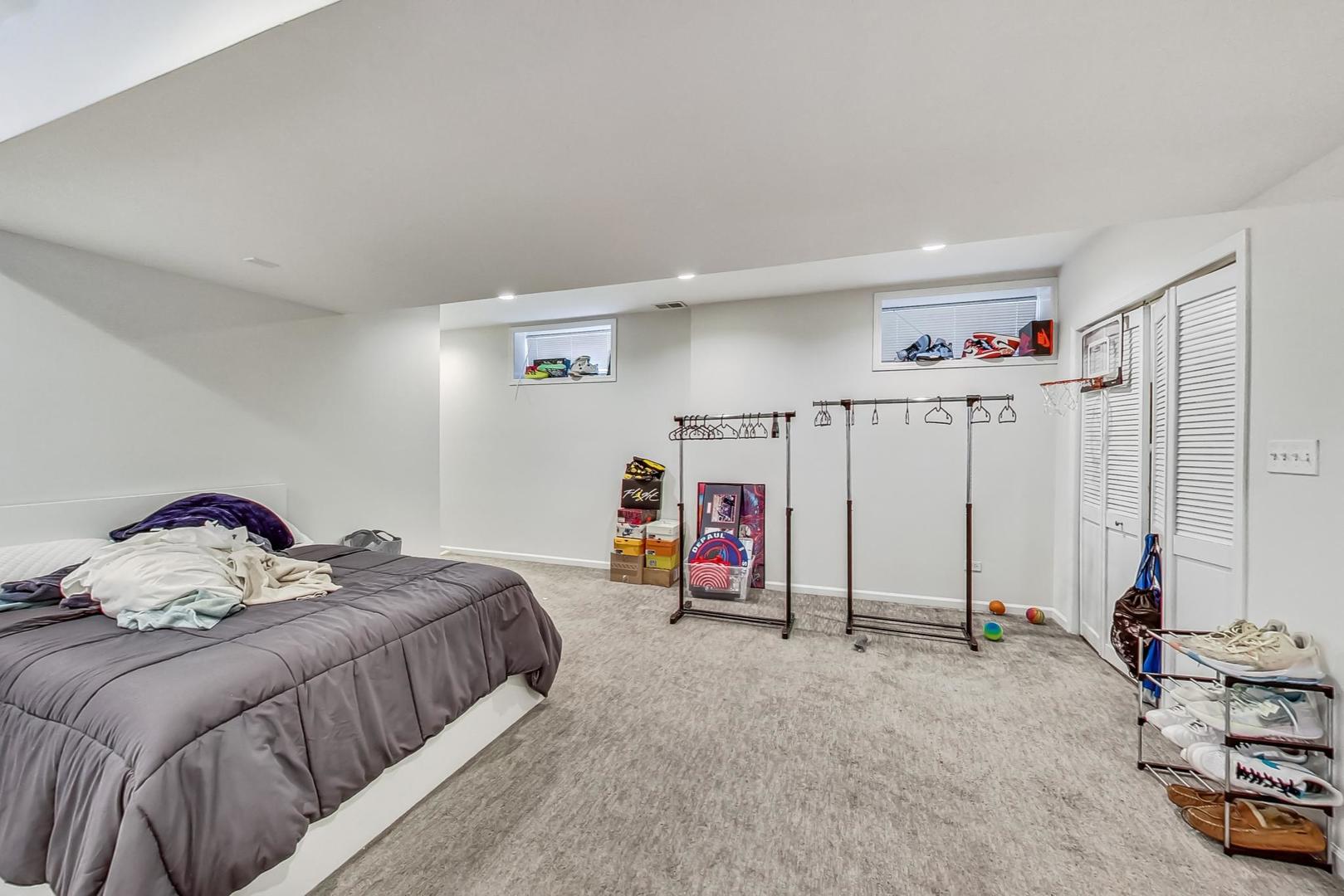 1119 West Addison Street Chicago, IL 60613 - Photo 17 of 36 a bedroom with a bed and a walk in closet