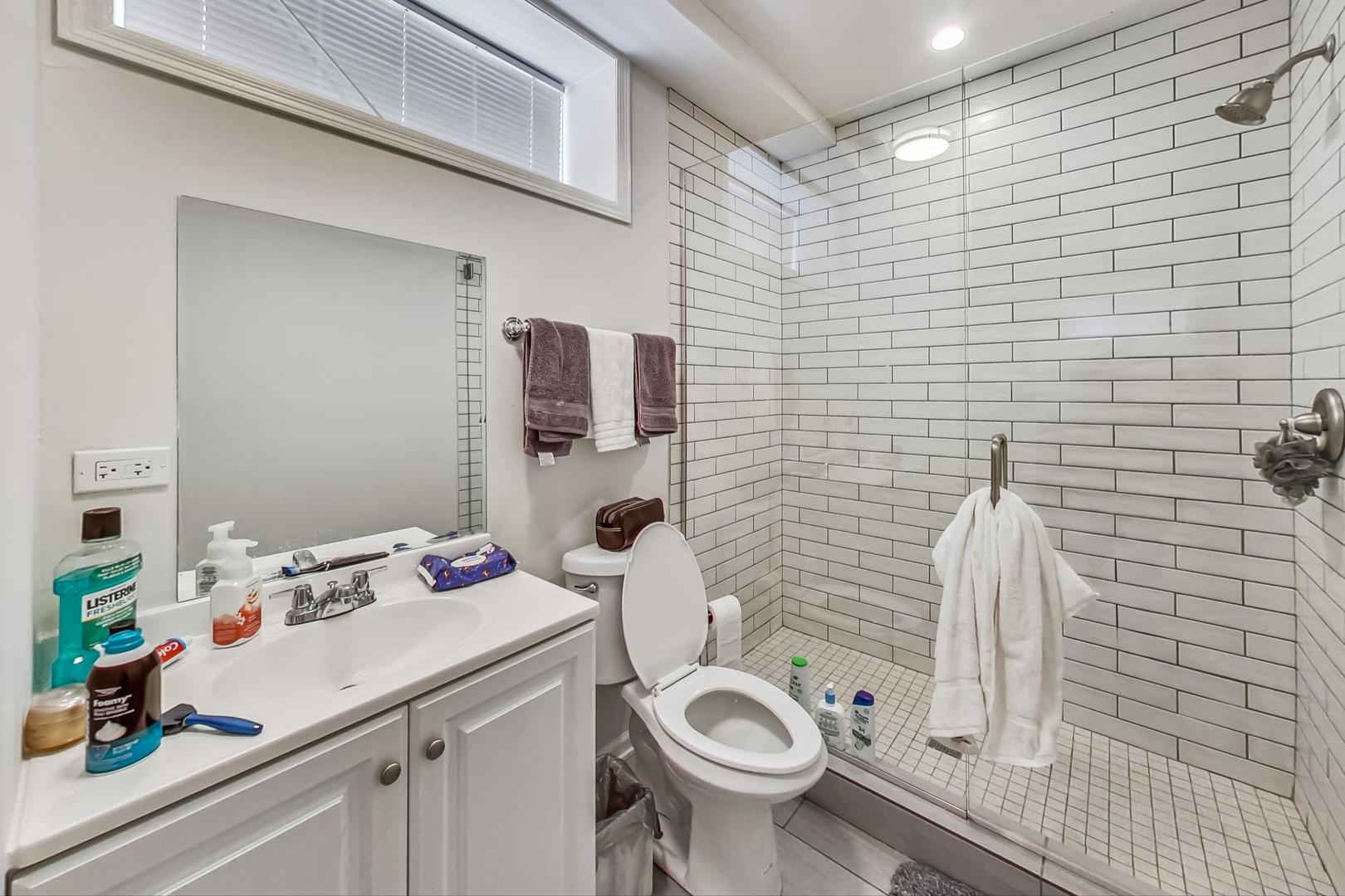 1119 West Addison Street Chicago, IL 60613 - Photo 22 of 36 a bathroom with a sink toilet and shower
