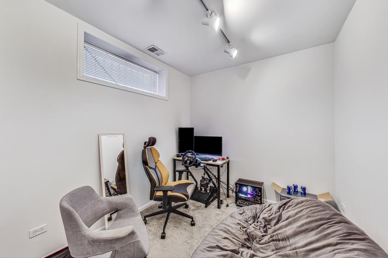 1119 West Addison Street Chicago, IL 60613 - Photo 23 of 36 a view of a workspace with furniture and a window