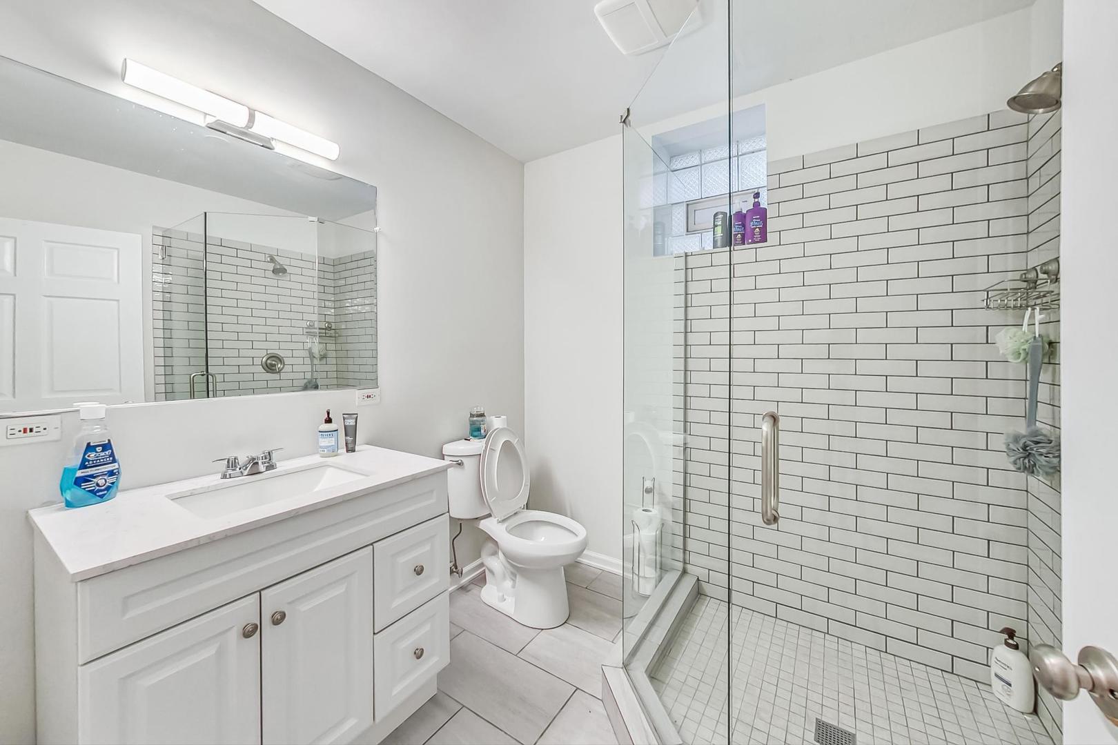 1119 West Addison Street Chicago, IL 60613 - Photo 24 of 36 a bathroom with a sink a toilet and shower