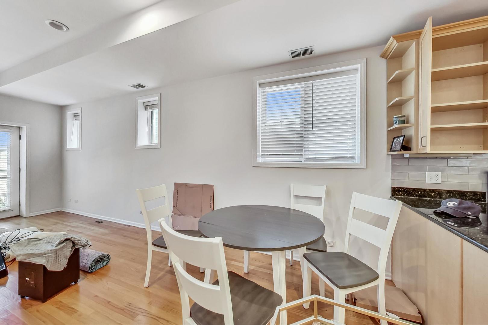 1119 West Addison Street Chicago, IL 60613 - Photo 26 of 36 a kitchen with a table and chairs in it