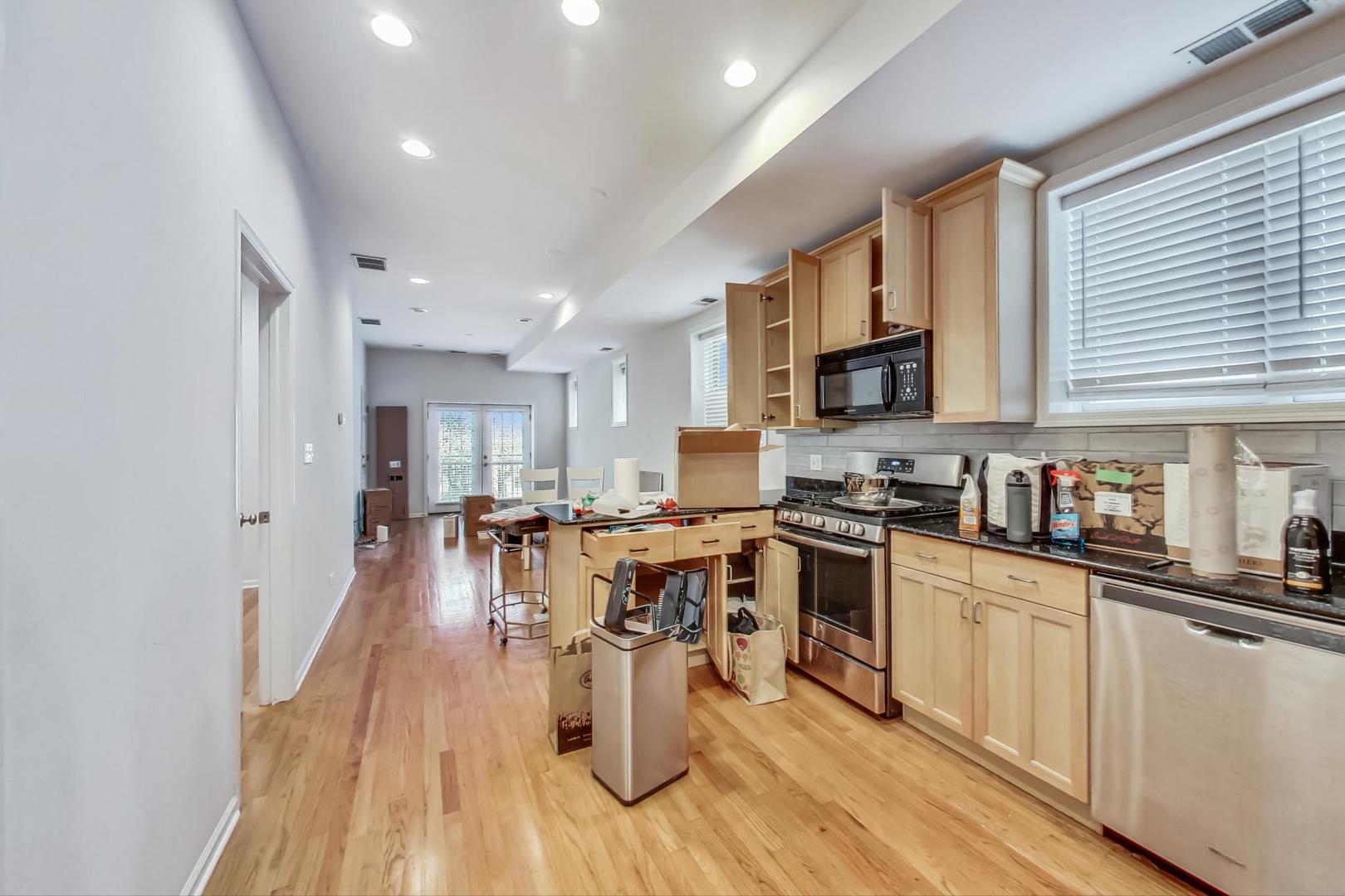 1119 West Addison Street Chicago, IL 60613 - Photo 27 of 36 a large kitchen with kitchen island lots of counter space a sink and appliances