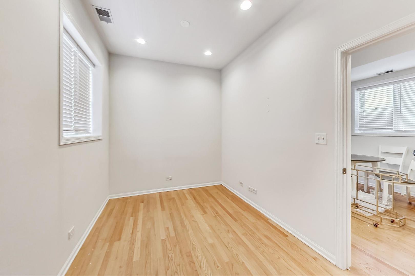1119 West Addison Street Chicago, IL 60613 - Photo 31 of 36 a view of a room with wooden floor and a window