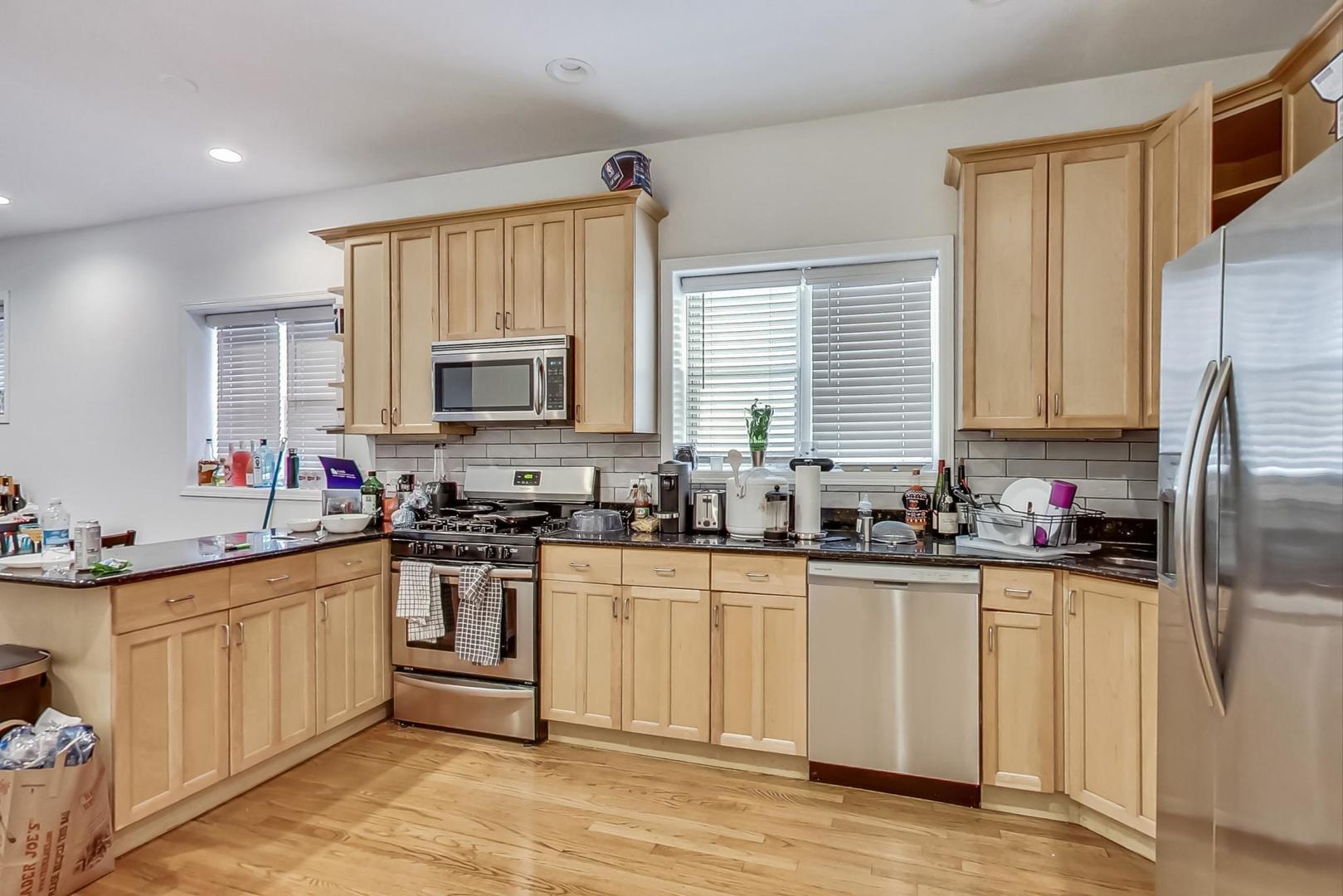 1119 West Addison Street Chicago, IL 60613 - Photo 9 of 36 a kitchen with a sink stove top oven and refrigerator