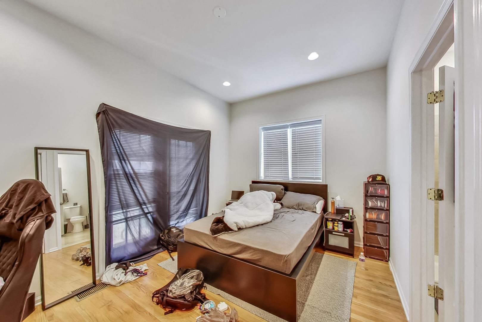 1119 West Addison Street Chicago, IL 60613 - Photo 10 of 36 a bedroom with furniture and a window