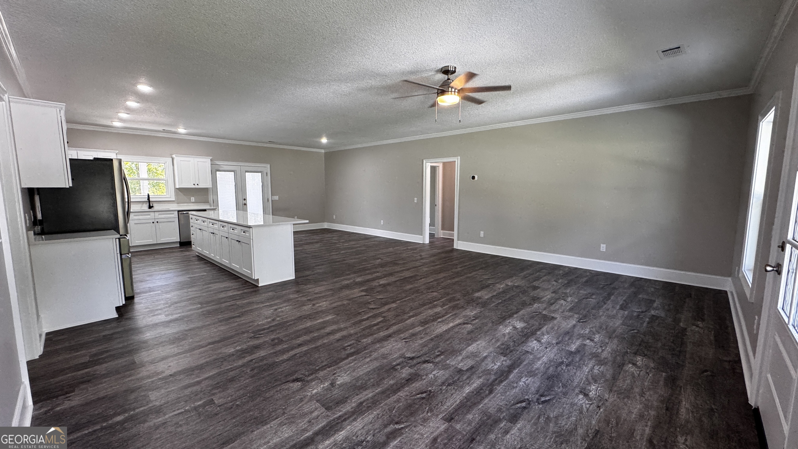 3 Willow Pointe Claxton, GA 30417 - Photo 17 of 31 a view of an empty room with wooden floor and a kitchen