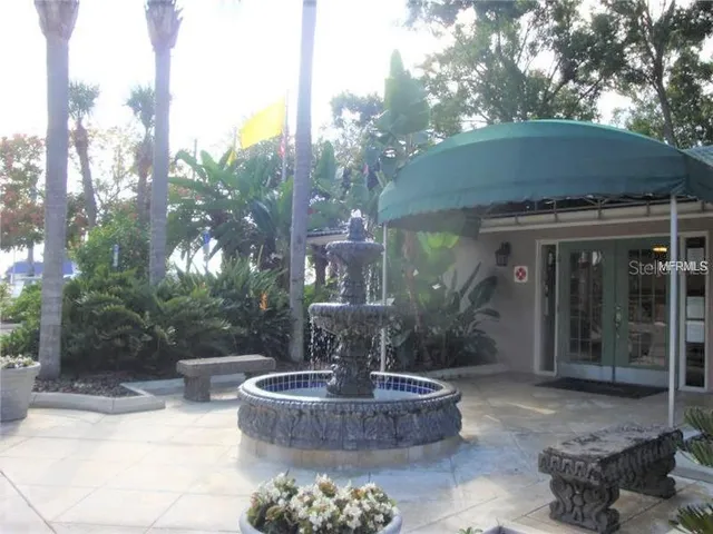 a view of a house with fountain in front of it
