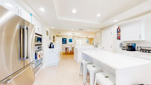 a kitchen with sink stove and refrigerator
