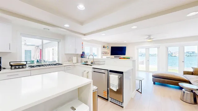 a kitchen with stainless steel appliances a refrigerator and a stove top oven