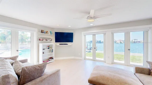 a bedroom with a bed and large windows