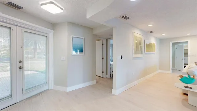 a bedroom with a bed and a flat tv screen