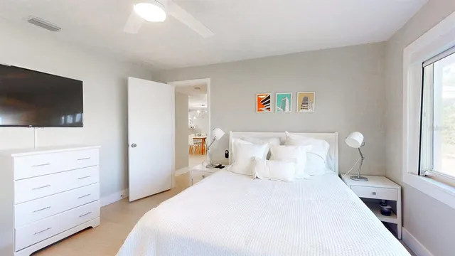 a bedroom with furniture and a flat screen tv
