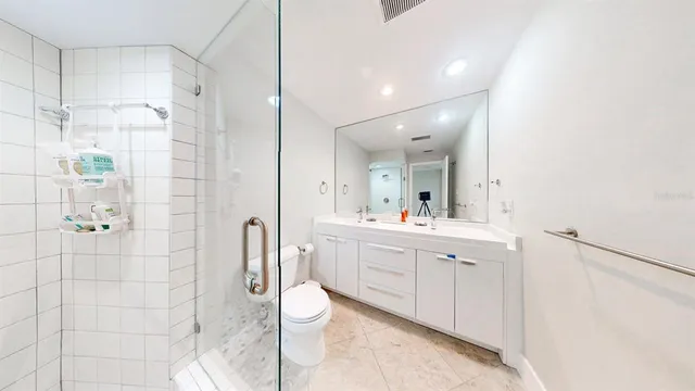 a spacious bedroom with a bed and a large window