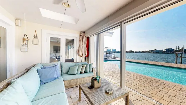 a living room with furniture and a floor to ceiling window