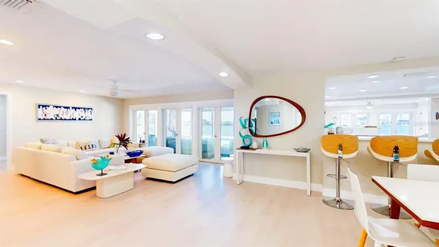 a view of a dining room with furniture a chandelier and wooden floor