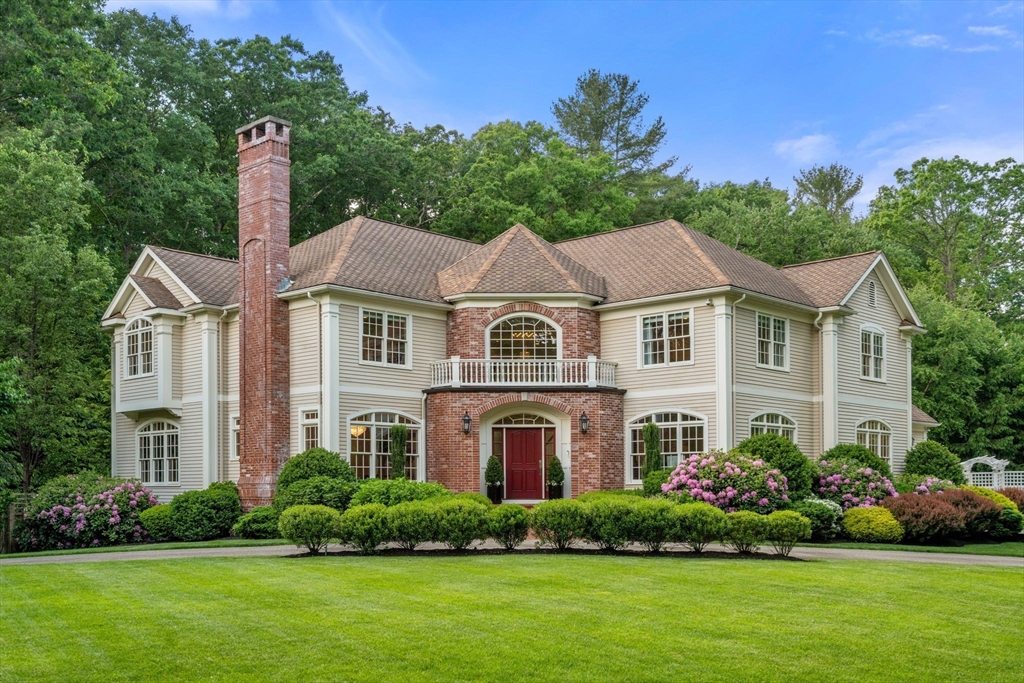 a front view of a house with a garden and plants