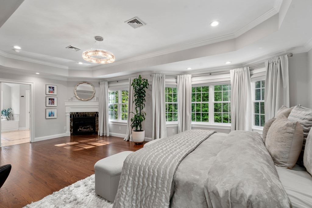 55 Radcliffe Road Weston, MA 02493 - Photo 18 of 38 a bed room with a bed and a fireplace