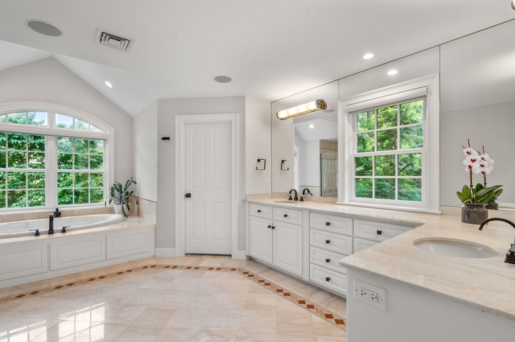 55 Radcliffe Road Weston, MA 02493 - Photo 19 of 38 a spacious bathroom with a granite countertop tub mirror and window