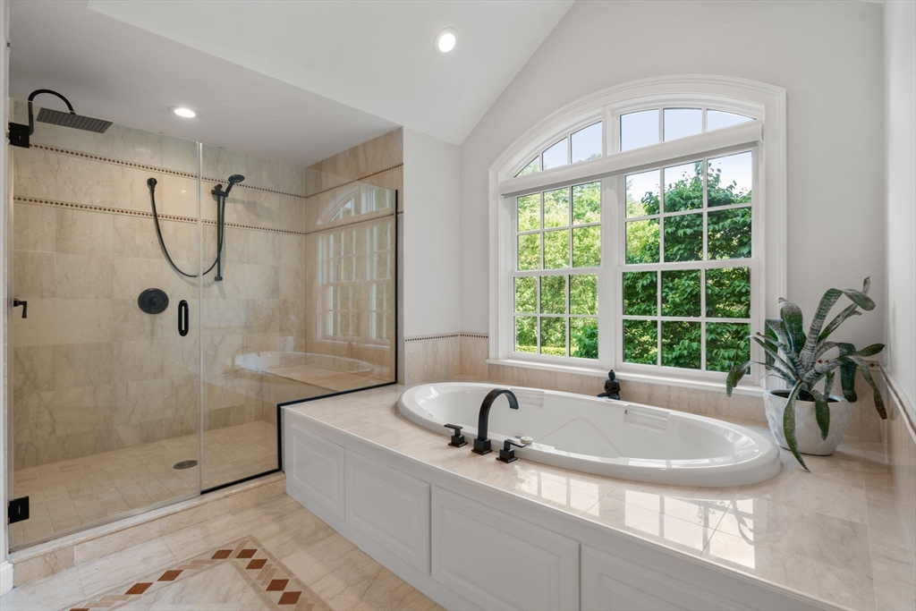 55 Radcliffe Road Weston, MA 02493 - Photo 20 of 38 a bathroom with a tub a sink and large windows