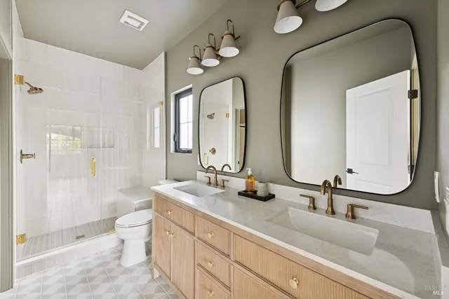 a bathroom with a double vanity sink mirror double and shower