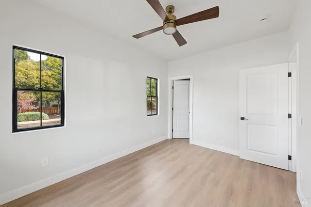 a view of room with hardwood floor and window