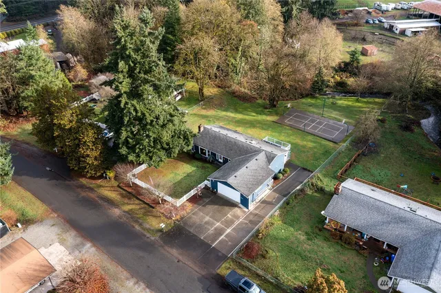an aerial view of a house with garden space and street view