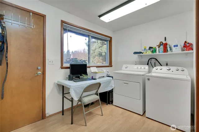 a view of a workspace with furniture and a window