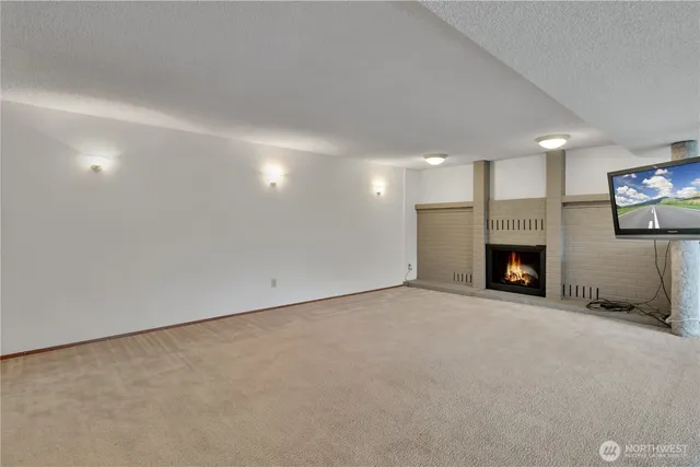 a view of an empty room with a fireplace
