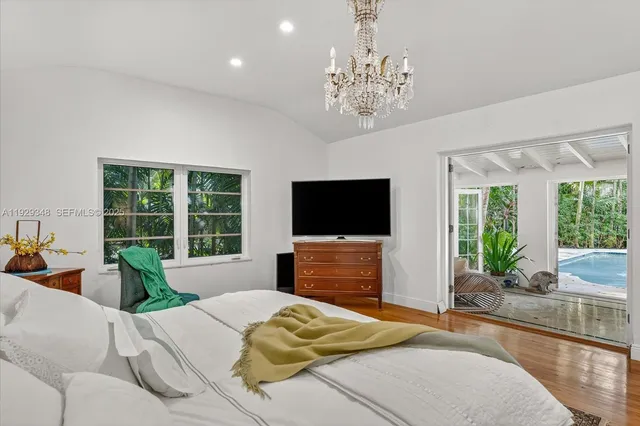 a living room with furniture and large windows