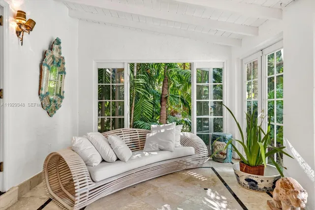 a large kitchen with kitchen island granite countertop lots of white cabinets and stainless steel appliances