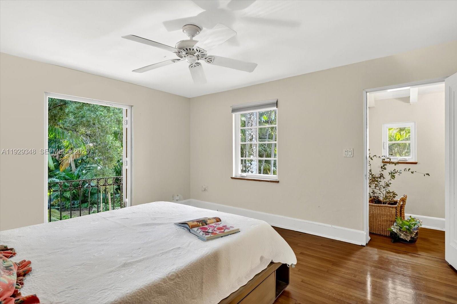 4190 Ingraham Highway Miami, FL 33133 - Photo 17 of 26 a bedroom with a bed and a chandelier