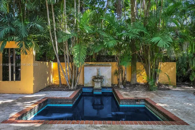 a view of a backyard with sitting area