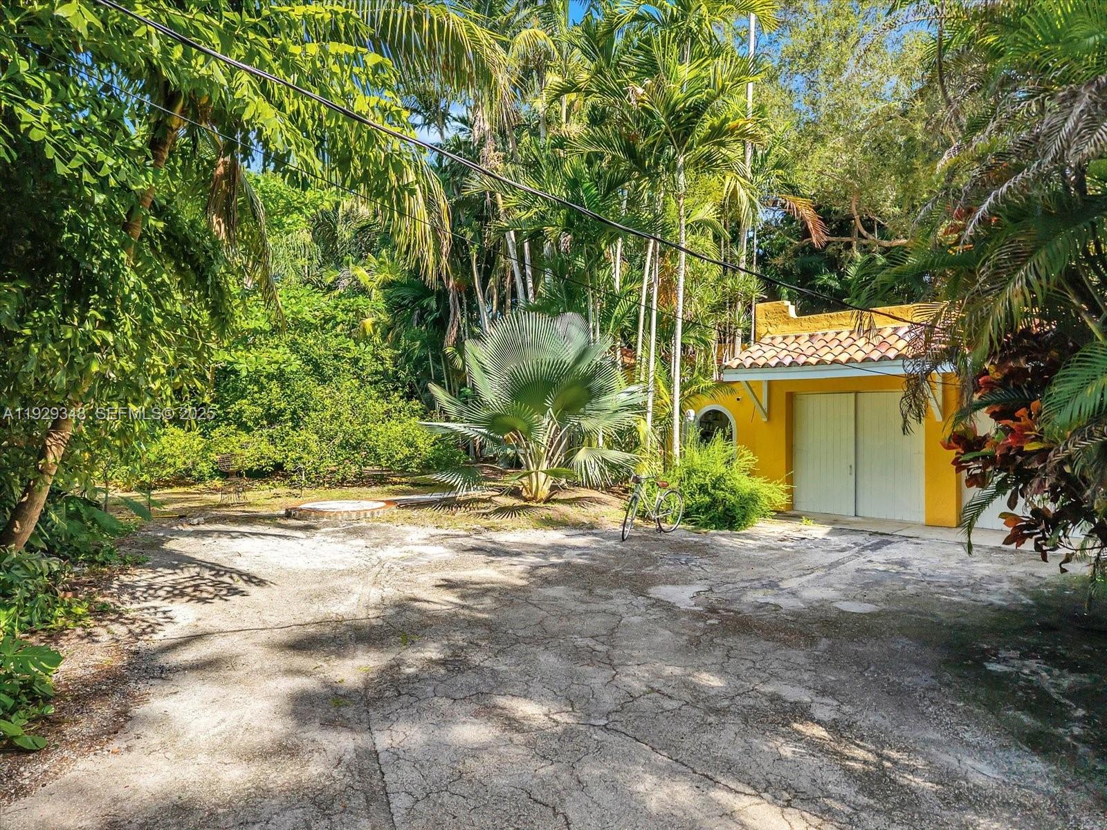 4190 Ingraham Highway Miami, FL 33133 - Photo 24 of 26 a view of a house with a tree and a yard