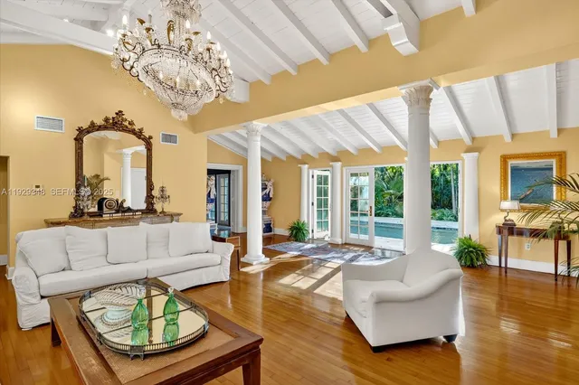 a living room with fireplace furniture and a large window