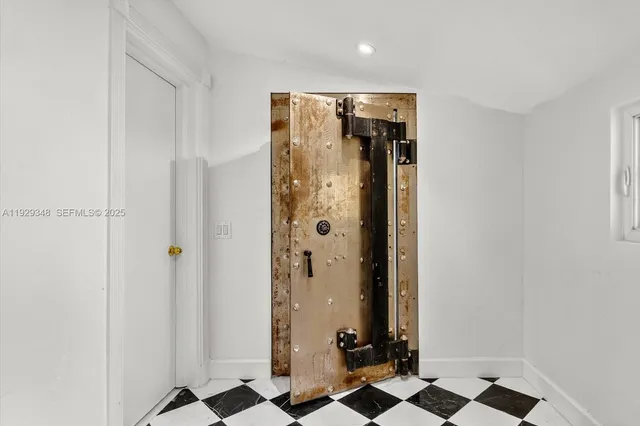 a view of an empty room with wooden floor and windows