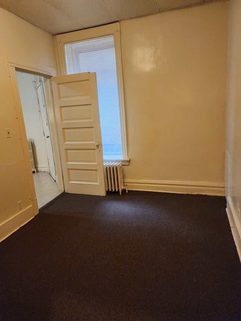6527 South Kimbark Avenue, Unit 1F Chicago, IL 60637 - Photo 12 of 18 a view of room with stairs and a window