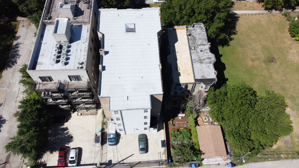 6527 South Kimbark Avenue, Unit 1F Chicago, IL 60637 - Photo 18 of 18 an aerial view of multiple houses with outdoor space